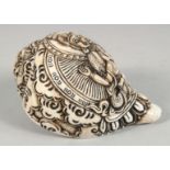 A LARGE CARVED CONCH SHELL WITH HINDU GOD. 16cm long.