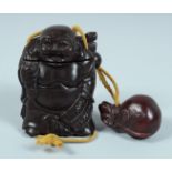 A JAPANESE CARVED WOOD BUDDHA INRO on a string. 8.5cm long