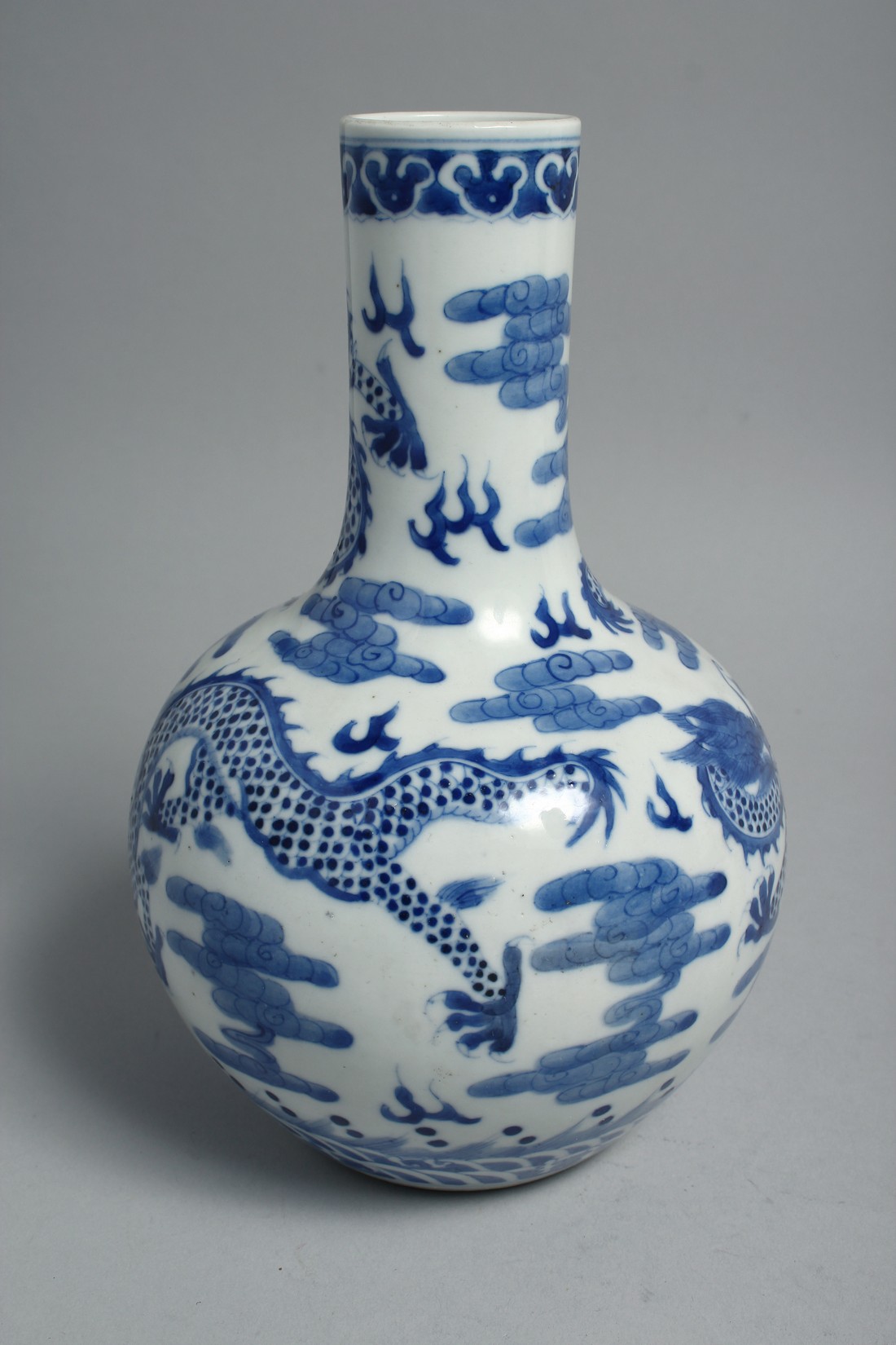 A CHINESE BLUE AND WHITE PORCELAIN BOTTLE VASE, painted with dragons and the flaming pearl of - Image 2 of 6