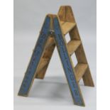 A NOVELTY PAIR OF BLUE FOLDING WOODEN STEPS.