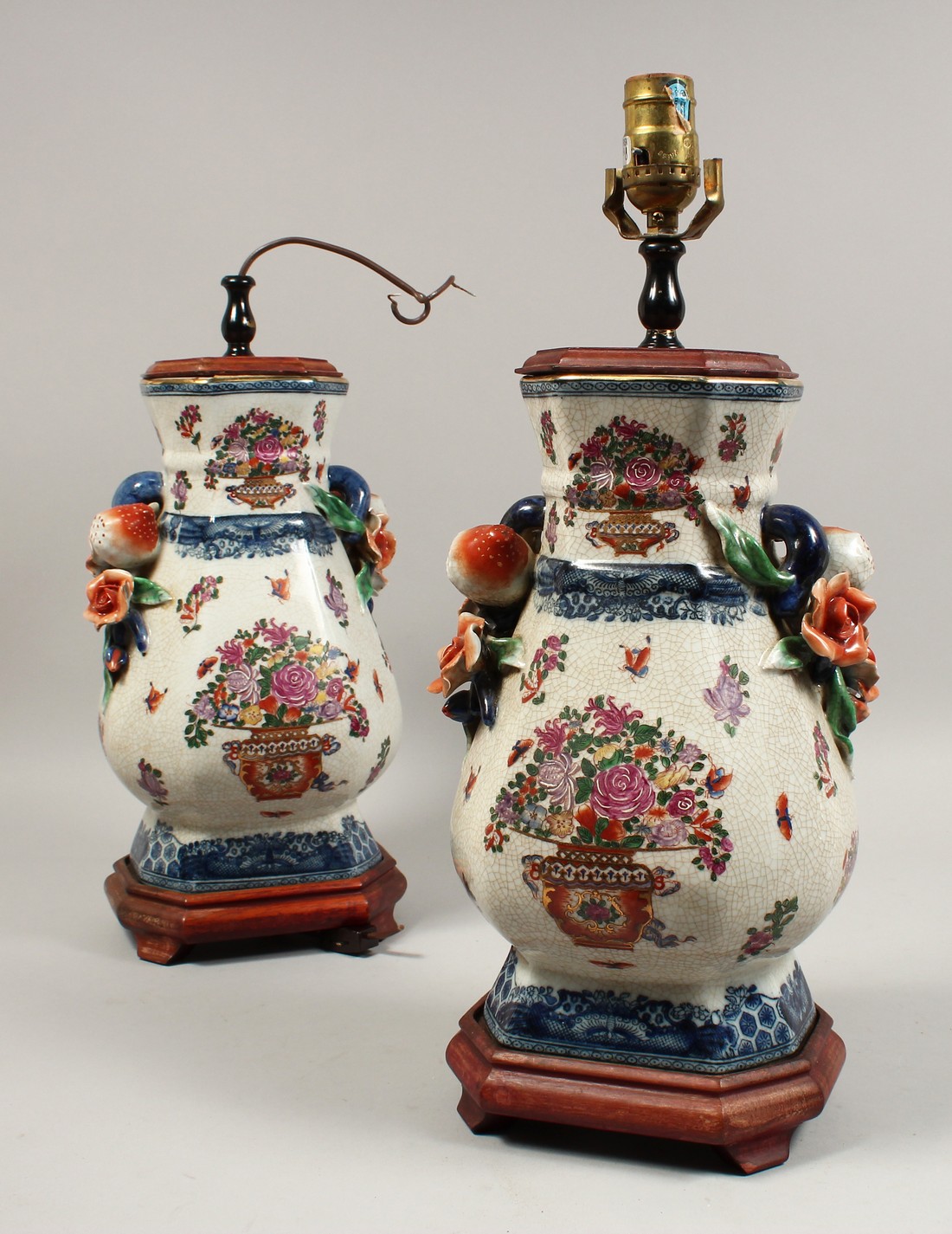 A PAIR OF PORCELAIN LAMPS with fruit handles. 17ins high.