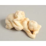 A CARVED BONE EROTIC NETSUKE. 2.5ins