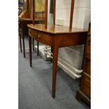 A mahogany bow front single drawer side table.