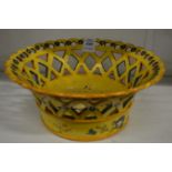 A continental yellow ground pottery pierced basket form dish.