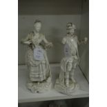A pair of white glazed continental porcelain figures (af).