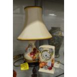 A modern Moorcroft table lamp decorated with butterflies and a matching desk clock.