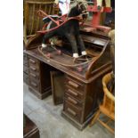 A Victorian mahogany roll top desk.