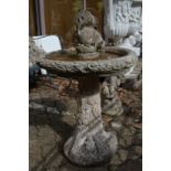 A composite garden bird bath complete with squirrel.