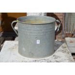 A galvanised twin handled planter.