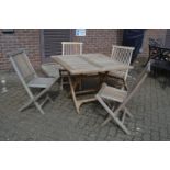 A hardwood folding garden table with four chairs.