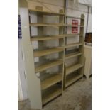 Two pale green painted floor standing shelves.