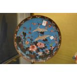 A Japanese cloisonne circular dish decorated with cranes and flowers.