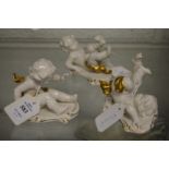 Three small continental porcelain figures of playful cherubs.