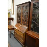 A George III mahogany bureau with associated bookcase upper section.