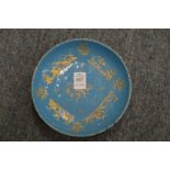 A pale blue enamelled dish with gilded decoration.