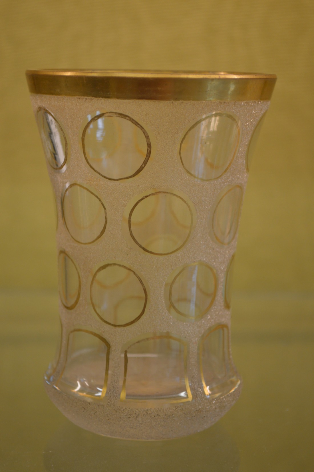 A gilt decorated glass beaker.