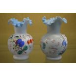 A pair of floral decorated opaque glass vases.