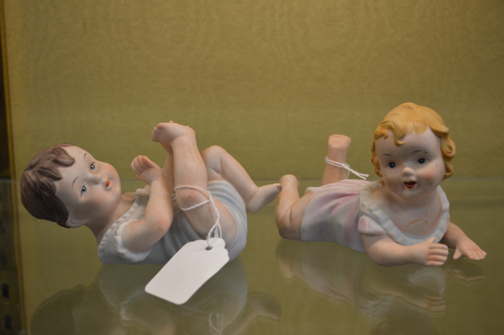 A pair of bisque porcelain babies.