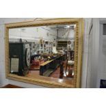 A large decorative gilt framed mirror.