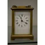 A brass carriage clock.