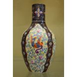 An enamel decorated opaque glass vase.