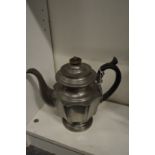 A pewter tea pot.