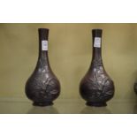 A pair of Japanese bronzed spelter bottle vases.