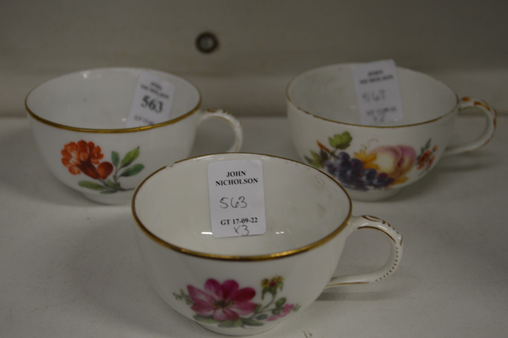 Three floral decorated continental porcelain cups.