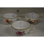 Three floral decorated continental porcelain cups.