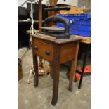 An old cast iron book press on stand.
