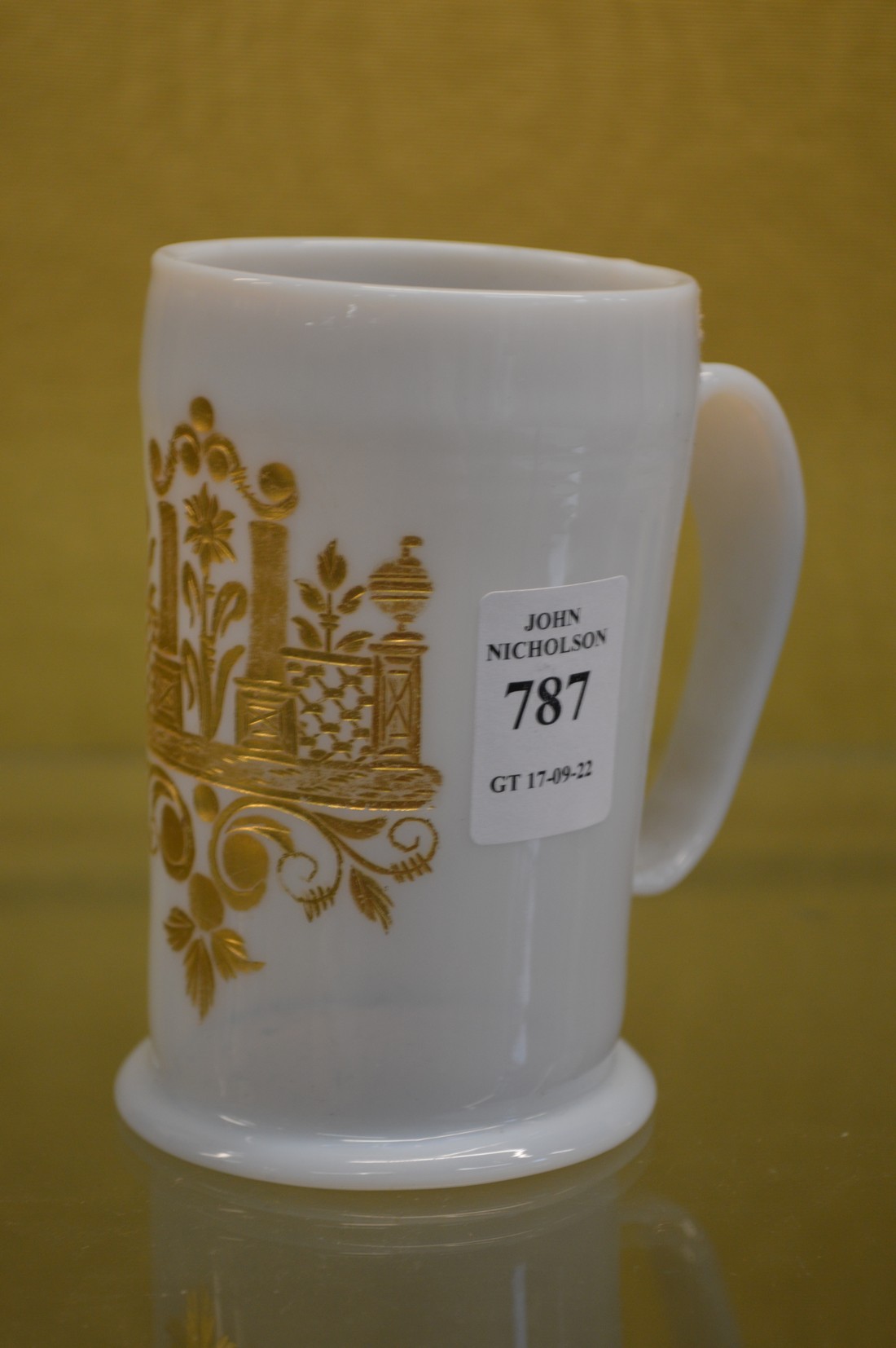 A Milch glass tankard with gilded decoration.