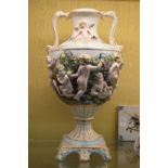 A pair of large Capodimonte urn shaped twin handled vases on pedestal bases.
