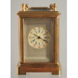 A MINIATURE GILT FACED CARRIAGE CLOCK. 2ins.