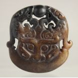 A CARVED ARCHAIC JADE PENDANT. 2ins