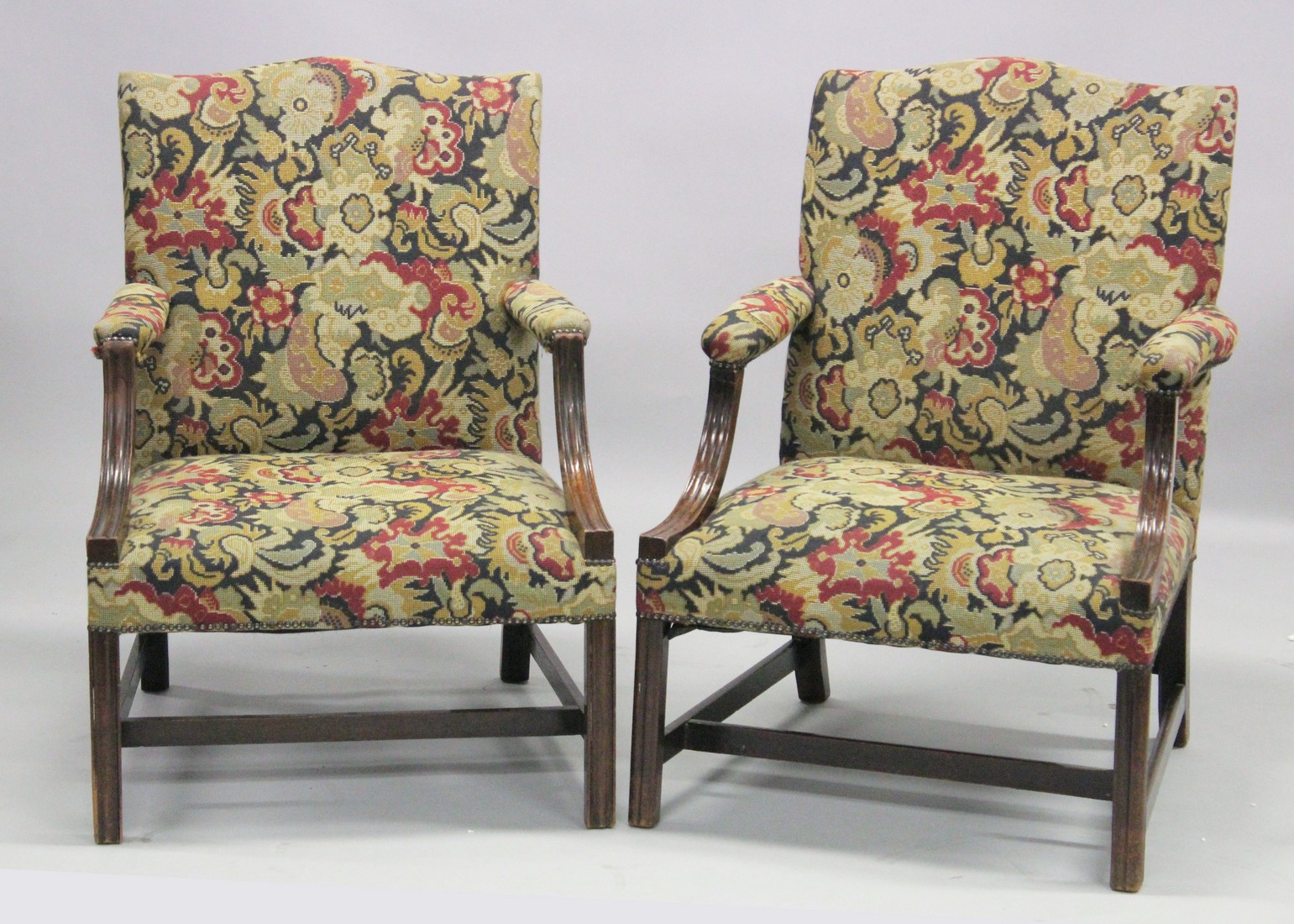 A NEAR PAIR OF GEORGIAN DESIGN MAHOGANY FRAMED GAINSBOROUGH ARMCHAIRS with tapestry back, arms and