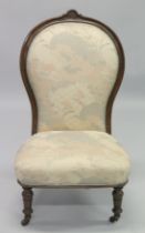 A VICTORIAN MAHOGANY FRAMED NURSING CHAIR with padded back and seat, on porcelain castors.