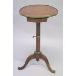 A 19TH CENTURY FRENCH CIRCULAR TOP CAMPAIGN TABLE on tripod base.