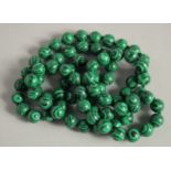 A STRING OF MALACHITE BEADS. 19ins long.