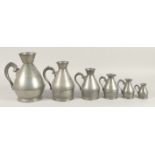 A GOOD SET OF SIX IRISH PEWTER HAYSTACK MEASURES, 1826 - 1840. 2.75ins to 9.5ins.