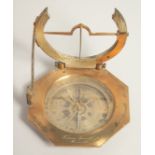 A GEORGIAN OCTAGONAL BRASS TRAVELLING COMPASS with silvered dial. Made in Paris. 3.75ins in a