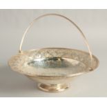 A VICTORIAN SILVER CIRCULAR BASKET with engraved and repousse decoration with headed edge and