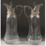 A VERY GOOD PAIR OF GLASS CLARET JUGS with plated mounts and lid. 11.5ins high.