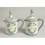 A PAIR OF 19TH CENTURY TIN GLAZE JUGS AND COVERS with pineapple finials. 7.5ins high.
