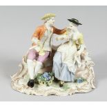 A GOOD FURSTENBERG PORCELAIN GROUP of a young man and girl siting on a bench, a basket of grapes
