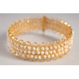 A GOOD GOLD AND THREE ROW SEED PEARL BRACELET.