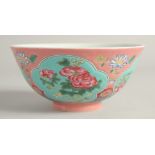 A CHINESE FAMILLE ROSE PORCELAIN BOWL, decorated with turquoise panels of native flora. 15ins