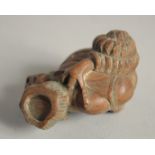 A JAPANESE CARVED WOOD SKULL NETSUKE Signed.