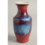 A SMALL FLAMBE STYLE GLAZE PORCELAIN VASE. 15.5cm high.