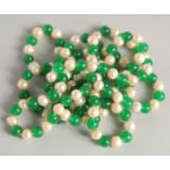 A STRING OF JADE AND PEARL BEADS. 48ins long.