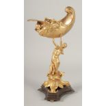 A GILT BRONZE COMPORT, a lady holding a shell on a triangular base. 1ft 3ins high.